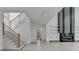 Open-concept living space featuring a staircase, open shelving, and modern fireplace at 165 Westbrook St, Buford, GA 30518