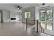 Living room with large windows, ceiling fan, and fireplace at 165 Westbrook St, Buford, GA 30518