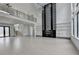 Open-concept living room with fireplace, modern lighting, and views of the second-floor balcony at 165 Westbrook St, Buford, GA 30518