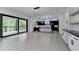 Living room showcases a seamless flow into a modern kitchen with a sliding glass door leading to the outdoors at 165 Westbrook St, Buford, GA 30518