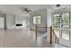 Modern living room with a fireplace, custom built-ins, and large windows showcasing an outdoor view at 165 Westbrook St, Buford, GA 30518