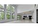 Bright living room with tall windows offering a beautiful view, flowing into the modern kitchen at 165 Westbrook St, Buford, GA 30518