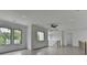 Upstairs living area with a ceiling fan, backyard views, and light-colored wood floors at 165 Westbrook St, Buford, GA 30518
