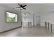 Upstairs loft area featuring recessed lights, a ceiling fan, modern lighting and railing with wooden trim at 165 Westbrook St, Buford, GA 30518