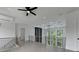 Upper-level loft with modern lighting, ceiling fan, trim railing, and scenic views from the window at 165 Westbrook St, Buford, GA 30518