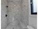 Modern bathroom features a glass enclosed shower with luxurious marble tiling and a convenient built in bench at 165 Westbrook St, Buford, GA 30518