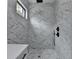 Elegant shower featuring marble tile, rainfall showerhead, and sleek fixtures at 165 Westbrook St, Buford, GA 30518