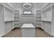 Large walk-in closet with a statement light fixture, central island and ample storage at 165 Westbrook St, Buford, GA 30518