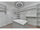 Large walk-in closet with custom storage solutions, island, and recessed lighting at 165 Westbrook St, Buford, GA 30518