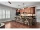 Charming bar area with stone detailing, wooden cabinetry, and barstool seating, perfect for entertaining at 3013 Walker Hill Way, Marietta, GA 30064