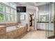Spa-like bathroom featuring a soaking tub, walk-in closet access, and elegant vanity at 3013 Walker Hill Way, Marietta, GA 30064