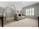 Comfortable bedroom with neutral carpet, dormer windows and a seating area at 3013 Walker Hill Way, Marietta, GA 30064