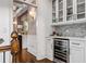 Butler's pantry with wine cooler, glass cabinets, and stylish backsplash at 3013 Walker Hill Way, Marietta, GA 30064