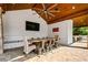 Covered dining area in pool cabana boasts brick pavers, vaulted wood ceiling and ceiling fan at 3013 Walker Hill Way, Marietta, GA 30064