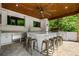 Outdoor cabana kitchen features marble countertops, stainless steel appliances, and bar seating at 3013 Walker Hill Way, Marietta, GA 30064