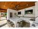 Fully-equipped outdoor kitchen with stainless steel appliances and views into lush backyard at 3013 Walker Hill Way, Marietta, GA 30064