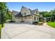 Charming home exterior with a three-car garage, large driveway, basketball hoop, and manicured landscaping at 3013 Walker Hill Way, Marietta, GA 30064