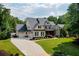 Beautiful two-story home with a three-car garage and a well-manicured lawn at 3013 Walker Hill Way, Marietta, GA 30064