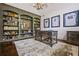 Spacious home office with built-in bookshelves, decorative lighting, and a large desk at 3013 Walker Hill Way, Marietta, GA 30064