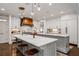 Bright, open kitchen features double islands, marble countertops, and a custom wood range hood at 3013 Walker Hill Way, Marietta, GA 30064