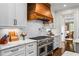 Modern kitchen features stainless steel appliances, custom hood, and sleek white cabinetry at 3013 Walker Hill Way, Marietta, GA 30064