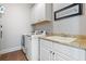 Well-lit laundry room with modern appliances, granite countertops, and ample storage at 3013 Walker Hill Way, Marietta, GA 30064