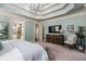 Spacious main bedroom featuring tray ceilings, a sitting area, and an en-suite bathroom at 3013 Walker Hill Way, Marietta, GA 30064