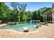 Lush backyard features a beautiful pool with waterfall slide and lounge chairs at 3013 Walker Hill Way, Marietta, GA 30064