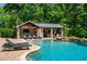 Inviting poolside cabana features a stone surround, bar, tv, lounge seating and more at 3013 Walker Hill Way, Marietta, GA 30064