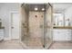 A luxurious tile shower with glass enclosure, dual shower heads, and adjacent vanity at 3013 Walker Hill Way, Marietta, GA 30064
