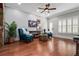 Cozy sitting room features two blue chairs, hardwood floors, and natural light from a large window at 3013 Walker Hill Way, Marietta, GA 30064