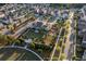 Scenic aerial view showcases lush landscaping, playground, central green, and charming homes in a planned community at 3380 Labrouste Cv, Duluth, GA 30097
