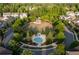 Serene aerial view of community green space with gazebo and water feature surrounded by lush trees and sidewalks at 3380 Labrouste Cv, Duluth, GA 30097