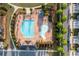 Overhead shot showcases a large community pool, with lap lanes and fountains surrounded by lounge chairs at 3380 Labrouste Cv, Duluth, GA 30097
