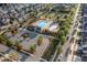 Aerial view shows a beautiful community pool, playground and green space nestled among homes and landscaping at 3380 Labrouste Cv, Duluth, GA 30097