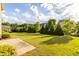 Large backyard with manicured lawn, trees, and well-maintained shrubbery at 3380 Labrouste Cv, Duluth, GA 30097