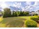 Yard with manicured lawn, evergreen trees, and well-maintained shrubbery at 3380 Labrouste Cv, Duluth, GA 30097