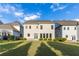 A backyard view of home featuring a manicured lawn and well-maintained shrubbery at 3380 Labrouste Cv, Duluth, GA 30097