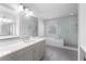 Bright bathroom featuring a walk-in shower, soaking tub, and stone countertops at 3380 Labrouste Cv, Duluth, GA 30097