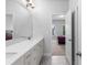 Bathroom with double vanity, white cabinets, and tile floor at 3380 Labrouste Cv, Duluth, GA 30097