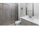 Modern bathroom featuring glass enclosed shower and bright vanity with a large mirror at 3380 Labrouste Cv, Duluth, GA 30097