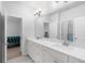 Bathroom with double vanity, white cabinets, and tile floor at 3380 Labrouste Cv, Duluth, GA 30097