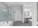 Bathroom featuring a glass shower, soaking tub, and granite countertops at 3380 Labrouste Cv, Duluth, GA 30097