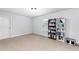 Well-lit bedroom with neutral paint, carpet, and built-in bookshelves at 3380 Labrouste Cv, Duluth, GA 30097