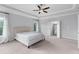 Spacious primary bedroom featuring tray ceiling and three large windows at 3380 Labrouste Cv, Duluth, GA 30097