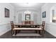 Traditional dining room featuring hardwood floors, modern chandelier, and bright, natural light at 3380 Labrouste Cv, Duluth, GA 30097