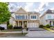 Charming home with stone accents, blue shutters, and an inviting covered front porch at 3380 Labrouste Cv, Duluth, GA 30097