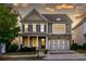 Charming two-story home featuring stone accents, blue shutters and a welcoming front porch at 3380 Labrouste Cv, Duluth, GA 30097