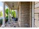 Covered front porch featuring stone accents, white columns and comfortable seating at 3380 Labrouste Cv, Duluth, GA 30097