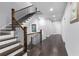 Hallway with hardwood floors and staircase with iron railings at 3380 Labrouste Cv, Duluth, GA 30097